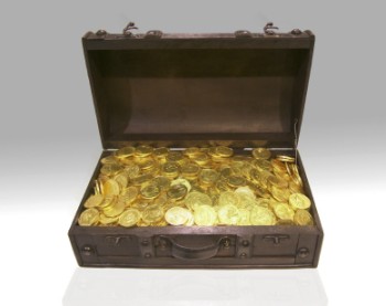 A dark wood, wooden chest full of gold coins