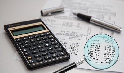 image of a calculator and bills image of a calculator and bills