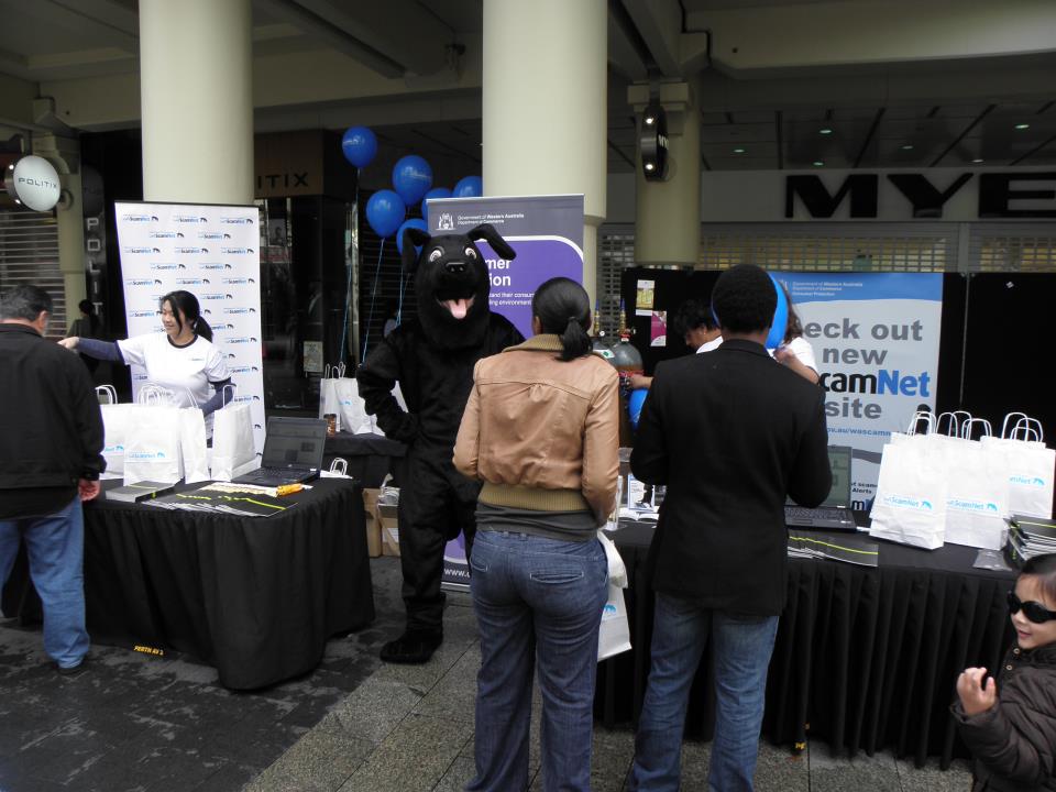A shot of the booth at the ScamNet launch showing Jet greeting the public