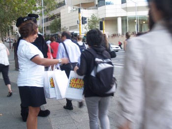 community education officer and Jet handing out "SlamScams" bags