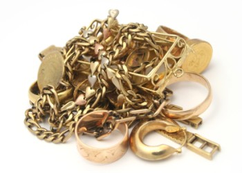 A pile of gold jewellery on a white background