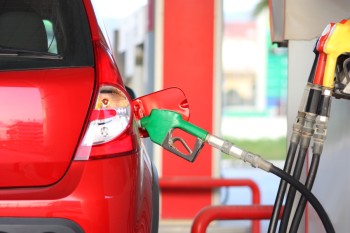 A red car with a fuel pump 